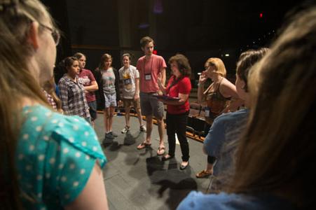 Students learning theater from a professor