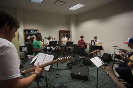 Students practice playing in a band together