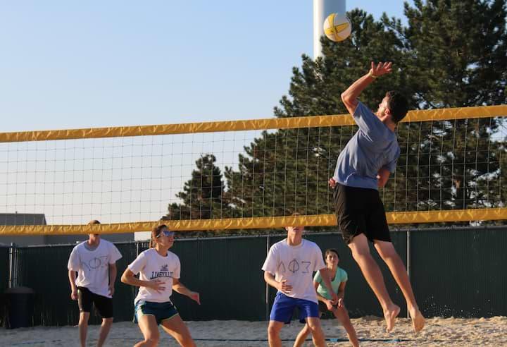 Students participate in sand volleyball